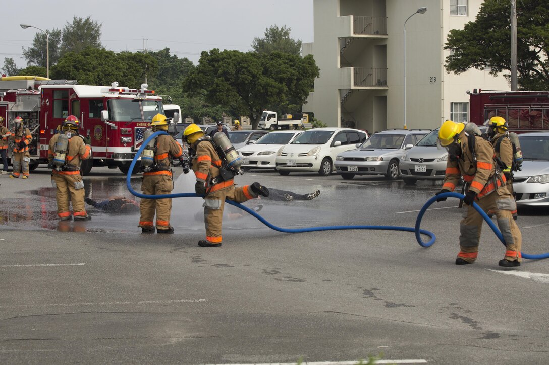 MCAS FUTENMA, OKINAWA, Japan – Firefighters spray down simulated casualties during a mass casualty exercise Sept. 28 on Marine Corps Air Station Futenma, Okinawa, Japan.