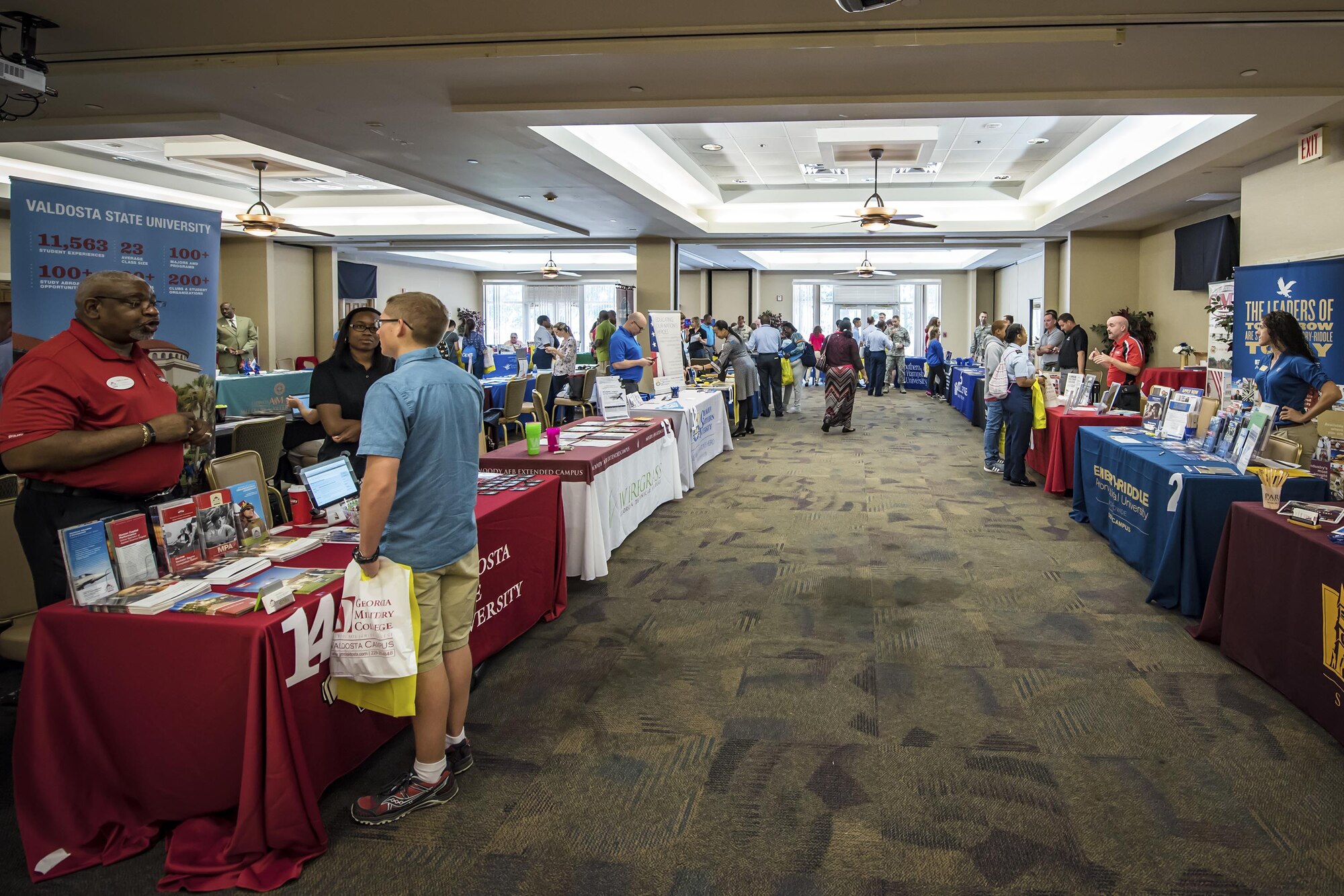 Representatives from universities speak to base and local community members during a National Education Fair, Oct. 3, 2017, at Moody Air Force Base, Ga. The event allowed attendees to explore higher education opportunities. (U.S. Air Force photo by Airman Eugene Oliver)