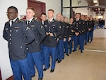 A line of young Soldiers at Joint Base San Antonio-Fort Sam Houston wait for their Mission Thanksgiving host families.