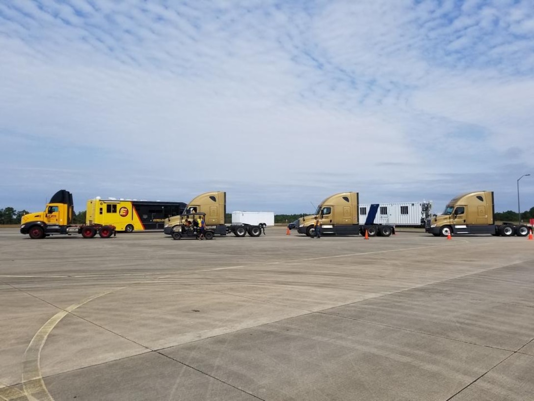 Trucks wait to retrieve trailers of hurricane relief supplies at Fort Bragg before carrying these supplies to a port in Florida.  The Federal Emergency Management Agency and Defense Logistics Agency are coordinating the distribution of hundreds of trailers filled with food, water, generators and other relief supplies for areas hit by hurricanes in recent weeks.