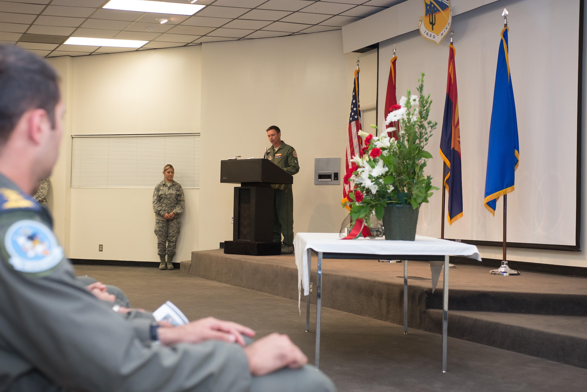 Director of Operations for the 152nd Fighter Squadron Detachment 1, Lt. Col. Jason Lewis speaks at a memorial service here Sept. 19.  “He gave his life for God and country in preparation for battle with ISIS and any other threat that serves to alter peace and civility in Iraq.  We owe our utmost reverence, for he is a true hero,” said Lewis.  “Know your bothers will take it from here and will ensure your sacrifice was not made in vein.”  (U.S. Air National Guard Photo by 1st Lt. Lacey Roberts)