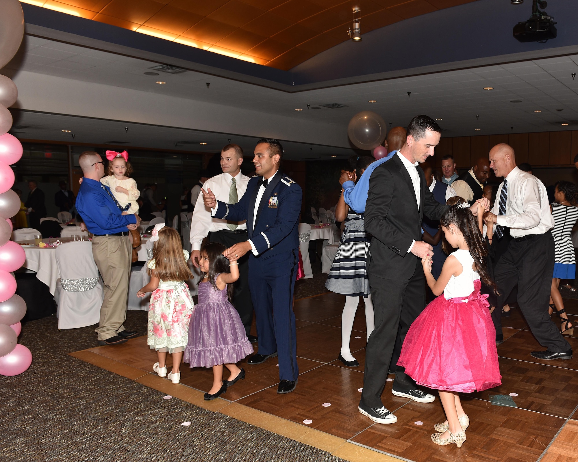 Fathers and daughters dancing