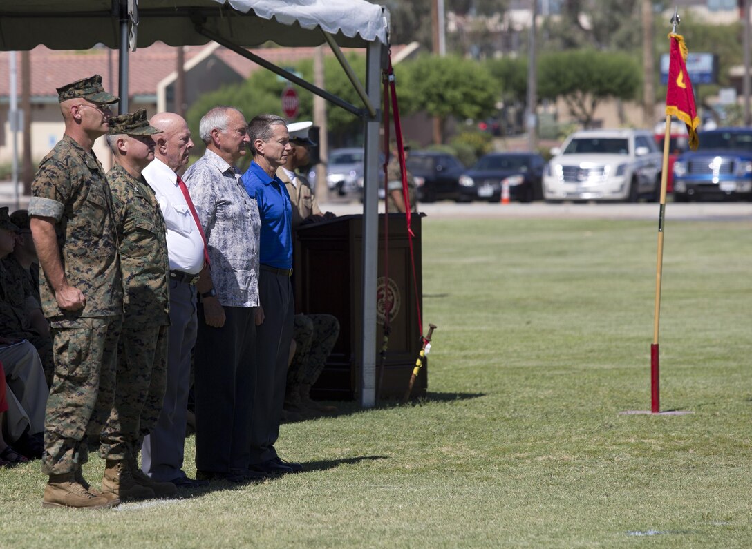 U.S. Marine Corps Col. David A. Suggs, the oncoming Marine Corps Air Station Yuma commanding officer, Col. Ricardo Martinez, the outgoing commanding officer, and previous commanding officers of MCAS Yuma take their post during the pass in review portion of their change of command ceremony at MCAS Yuma, Ariz., June 27, 2017. (U.S. Marine Corps by Lance Cpl. Joel Soriano)