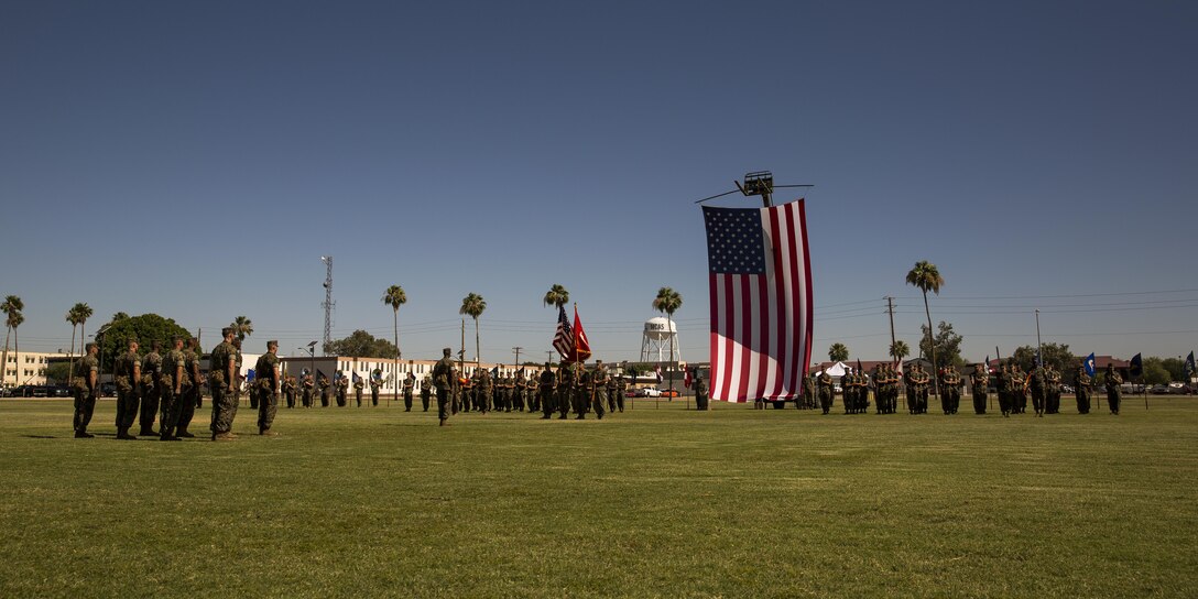 U.S. Marines prepare to salute the colors as the 3rd Marine Aircraft Wing Band performs the national anthem during the Marine Corps Air Station Yuma, Ariz., change of command ceremony held at the parade field Tuesday, June 27, 2017. During the ceremony, Col. Ricardo Martinez, the outgoing commanding officer, relinquished his command to Col. David A. Suggs, the oncoming commanding officer. (U.S. Marine Corps photo taken by Lance Cpl. Christian Cachola)