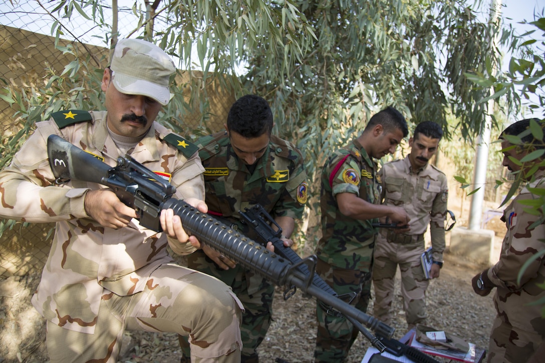 Iraqi security forces trainers disassemble an M16 rifle before they teach their fellow trainers at Camp Taji, Iraq.