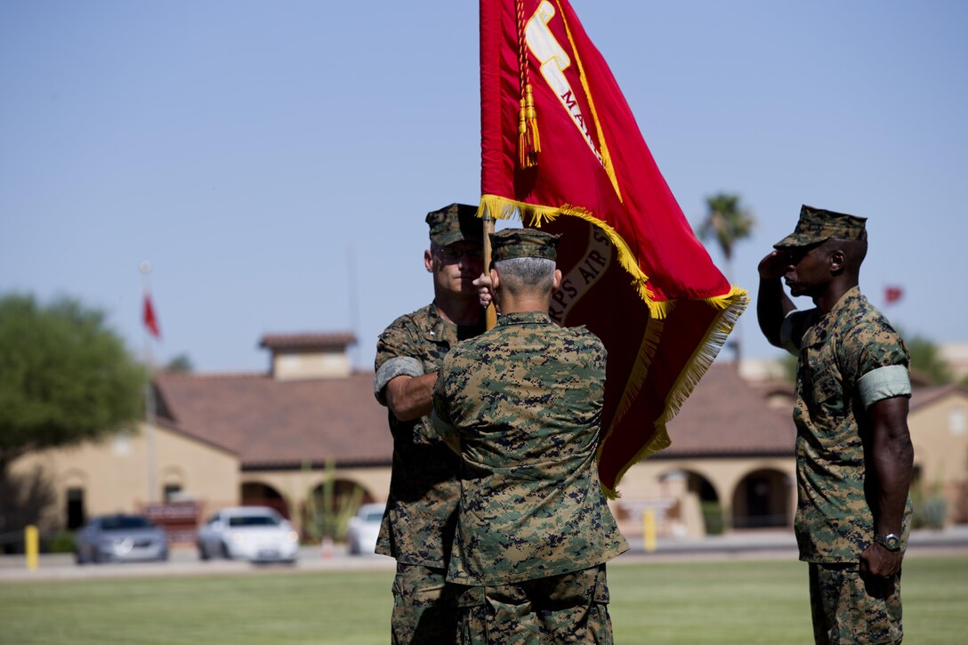 U.S. Marine Corps Col. Ricardo Martinez, Marine Corps Air Station Yuma outgoing commanding officer, passes the colors to the oncoming commanding officer, Col. David A. Suggs during their change of command ceremony at MCAS Yuma, Ariz., June 27, 2017. (U.S. Marine Corps photo by Lance Cpl. Joel Soriano)