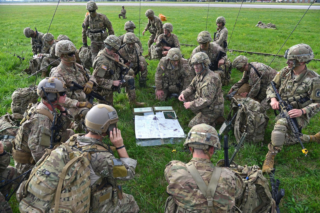 U.S. soldiers conduct a mission briefing after jumping from an Air Force C-130 Hercules aircraft at Rivolto Air Base in Udine, Italy.