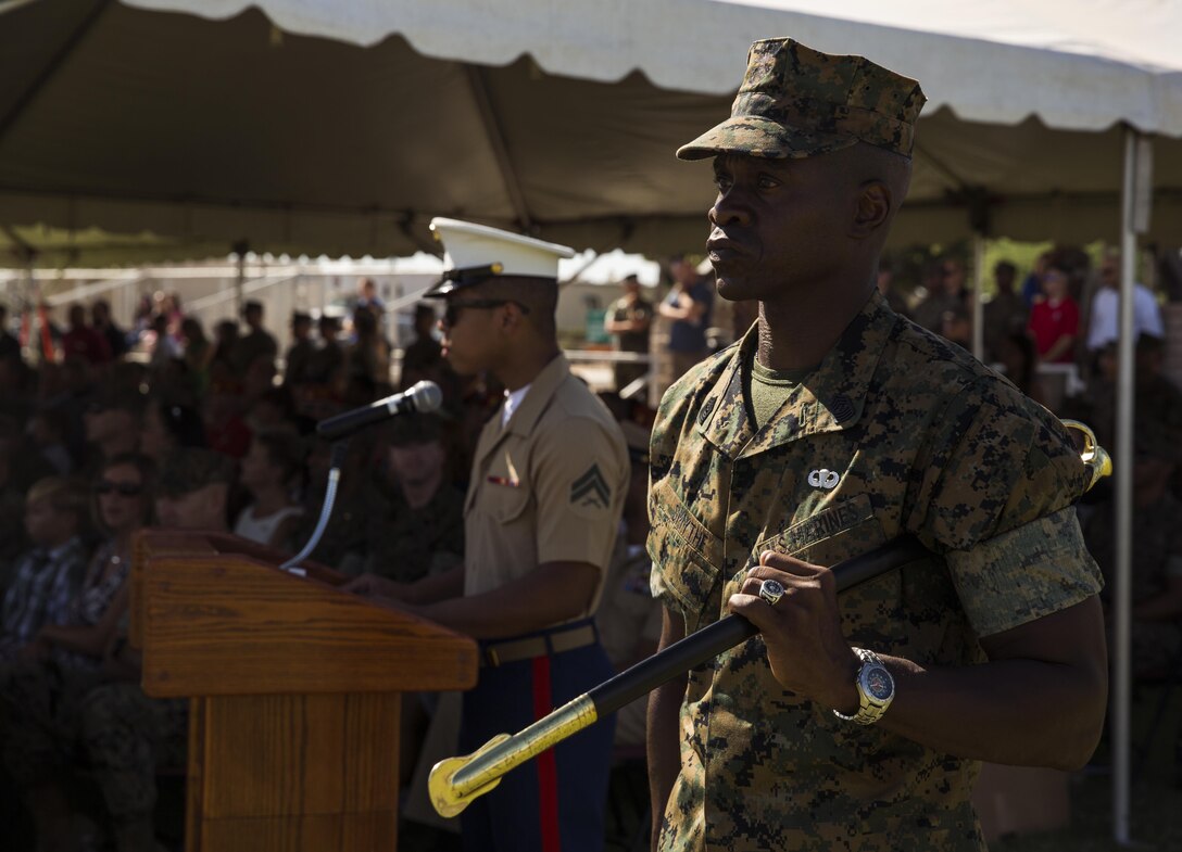 U.S. Marine Corps Sgt. Maj. Delvin R. Smythe, the Marine Corps Air Station (MCAS) Yuma, Ariz., segeant major, transfers the sword to Master Gunnery Sgt. Arthur Parra, who will serve as an acting sergeant major, during Sgt. Maj. Smythe's retirement ceremony, June 30, 2017. (U.S. Marine Corps photo taken by Lance Cpl. Christian Cachola)