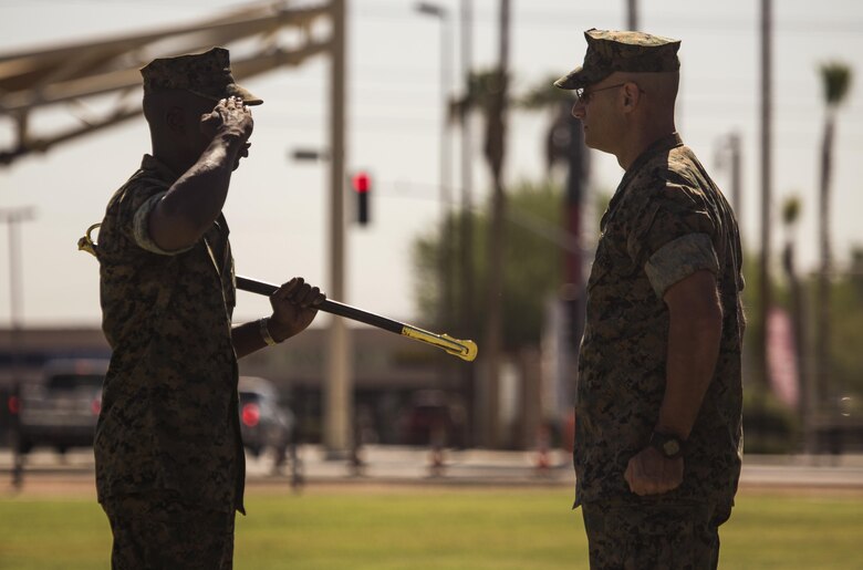 U.S. Marine Corps Sgt. Maj. Delvin R. Smythe, the Marine Corps Air Station (MCAS) Yuma, Ariz., segeant major, transfers the sword to Master Gunnery Sgt. Arthur Parra, who will serve as an acting sergeant major, during Sgt. Maj. Smythe's retirement ceremony, June 30, 2017. (U.S. Marine Corps photo taken by Lance Cpl. Christian Cachola)