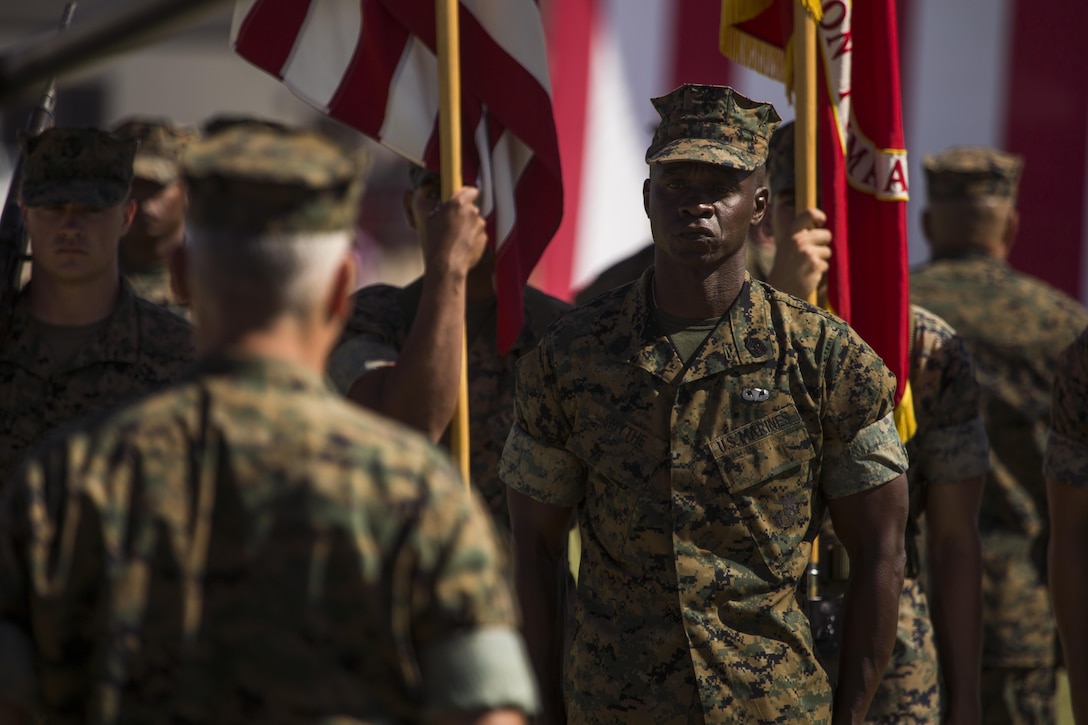 U.S. Marine Corps Sgt. Maj. Delvin R. Smythe, the Marine Corps Air Station (MCAS) Yuma, Ariz., sergeant major, receives awards from Col. Ricardo Martinez, the outgoing commanding officer of MCAS Yuma, and Master Gunnery Sgt. Arthur Parra, the acting sergeant major of MCAS Yuma, during Sgt. Maj. Smythe's retirement ceremony, June 30, 2017. (U.S. Marine Corps photo taken by Lance Cpl. Christian Cachola)