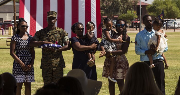 U.S. Marine Corps Sgt. Maj. Delvin R. Smythe, the Marine Corps Air Station (MCAS) Yuma, Ariz., sergeant major, completes the ceremony with his family during Sgt. Maj. Smythe's retirement ceremony, June 30, 2017. (U.S. Marine Corps photo taken by Lance Cpl. Christian Cachola)