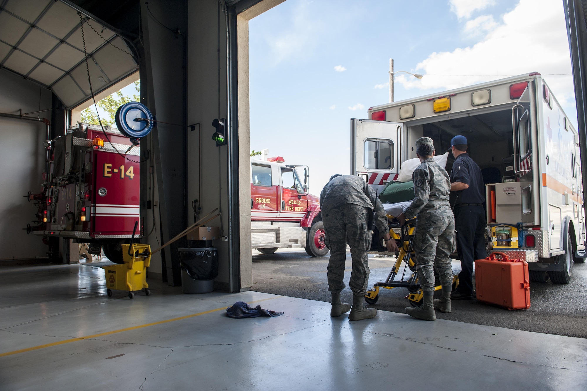 Medics with the 9th Medical Group, restock an ambulance with gear at Station 2 at Beale Air Force Base, California, Oct. 3, 2017. Medics and firefighters at Station 2 are dispatched over the same system decreasing the time it takes for members to respond to calls. (U.S. Air Force photo/Senior Airman Justin Parsons)