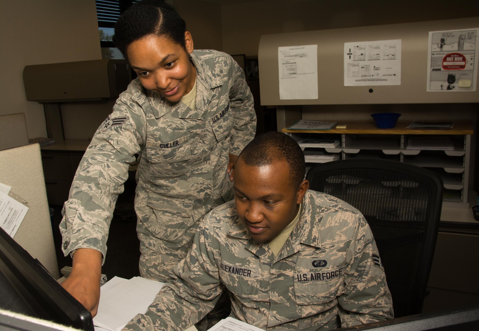 Senior Airmen Taylor Culler and Jabari Alexander, 349th Air Mobility Wing travel technicians, run through e-finance training at Travis Air Force Base, Calif., on Oct. 3, 2017. The 349th travel pay office will be opening a new location in Bldg. 381 to help accommodate more customers.