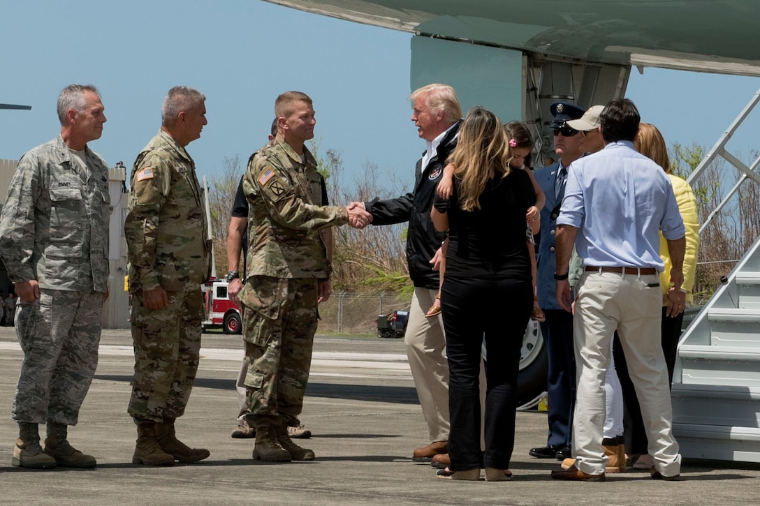 The president shakes hands with an Army general.