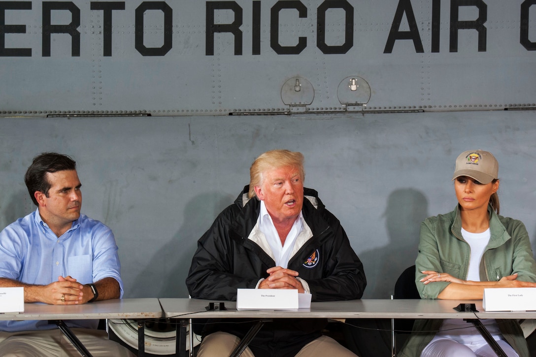 Three people sit at a table.