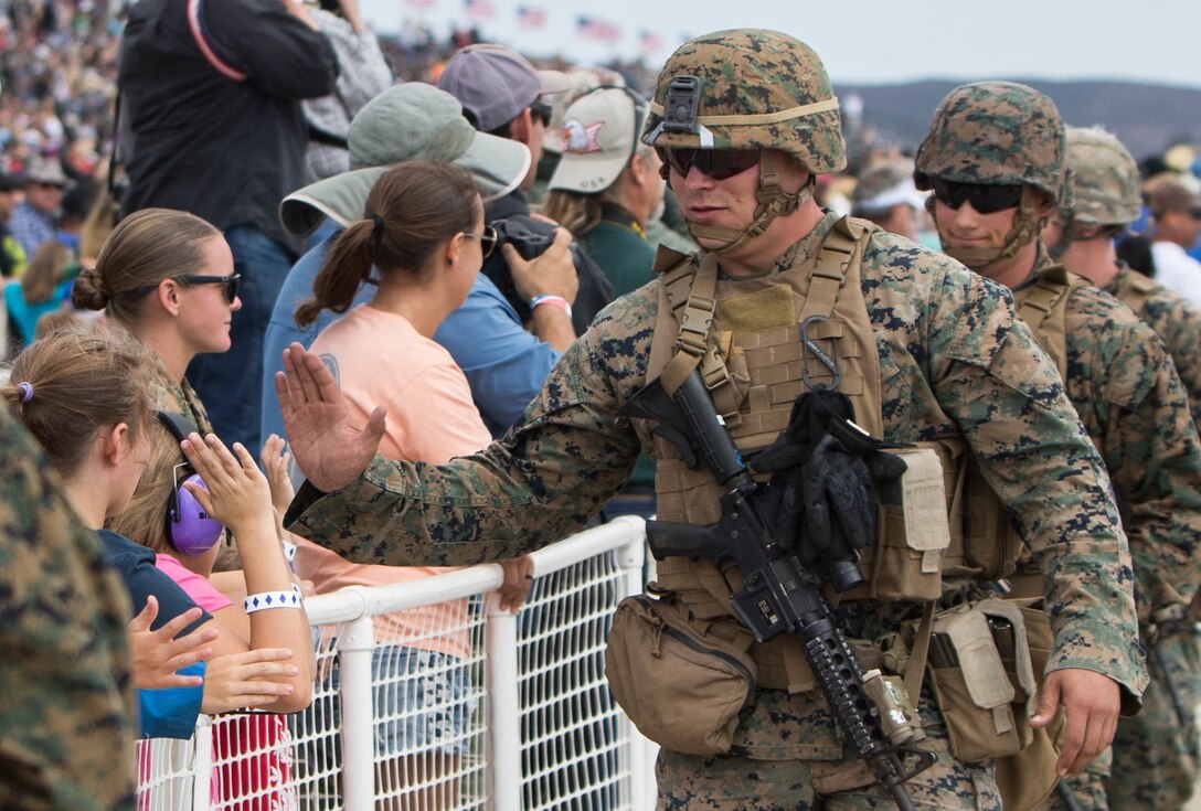 Marines with 1st Marine Division greet spectators at the 2017 Marine Corps Air Station Miramar Air Show at MCAS Miramar, Calif., Sept. 23. The theme for the air show is “A Salute to Vietnam Veterans” and features several performances and displays recognizing the sacrifices of Vietnam veterans. The air show also showcases world-class civilian performers, military flight demonstration teams, capabilities of the Marine Air-Ground Task Force and celebrates our longstanding relationship with our neighbors in the local San Diego community. (U.S. Marine Corps photo by Cpl. Nathaniel McAllister/Released)