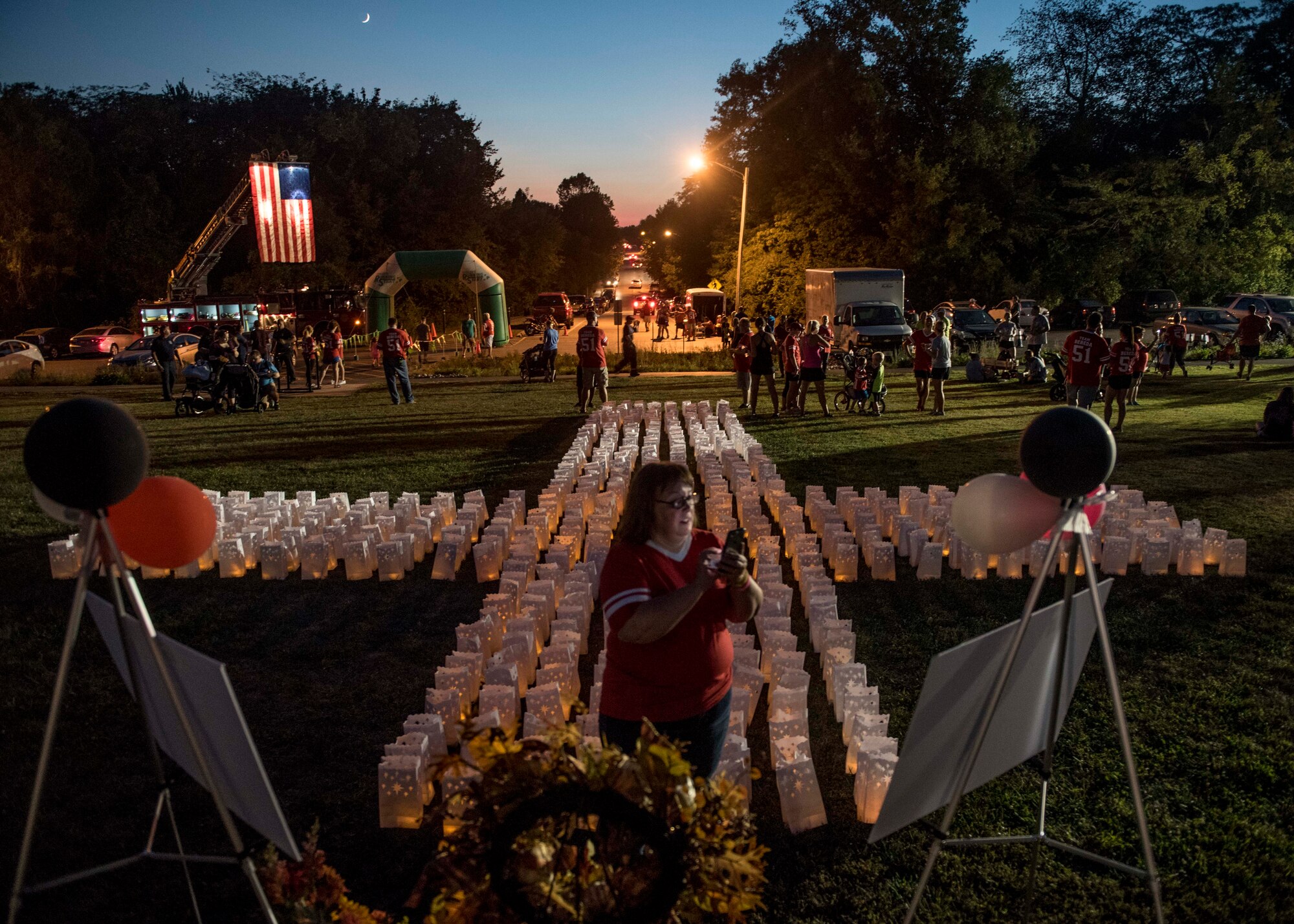 The fire department and over 500 community members came to the event, where over 700 luminaries, a wreath, and two posters with pictures of the family stretched across the Rock Spring Park, O’Fallon, Ill., Sept. 23, 2017.  (U.S. Air Force photo by Tech. Sgt. Jodi Martinez)