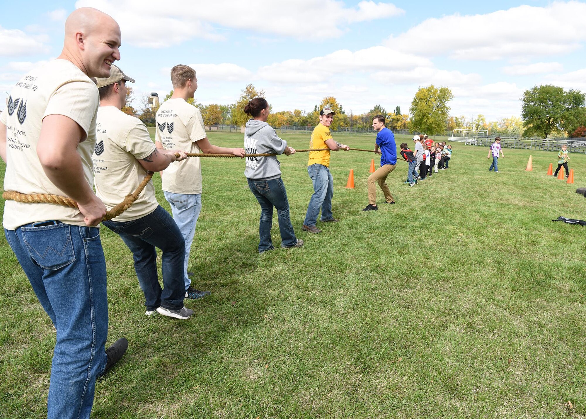 Members of the Network 5/6 play a game of tug-of-war with children during a kid’s deployment day event Sept. 29, 2017, at Grand Forks Air Force Base, North Dakota. The goal of deployment day was to give children a feel of what a deployment is like. (U.S. Air Force photo/Senior Airman Cierra Presentado)