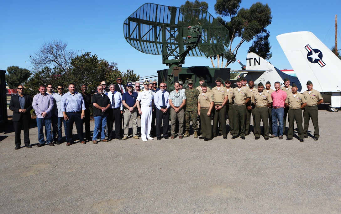 Active-duty and retired Marines, who employed the TPN-22 and a TPS-73 radar systems, give a final farewell before the systems are inducted into the Flying Leatherneck Aviation Museum at Marine Corps Air Station Miramar, Calif., Sept. 28. Following an earlier retirement ceremony at MCAS  Yuma, the TPN-22 and the TPS-73 radar systems were officially retired and put on display for museum visitors to enjoy. Both radar systems were used for tracking and guiding aircraft in forward deployed scenarios when air traffic control towers were not available. (Marine Corps photo by Sgt. David Bickel/Released)