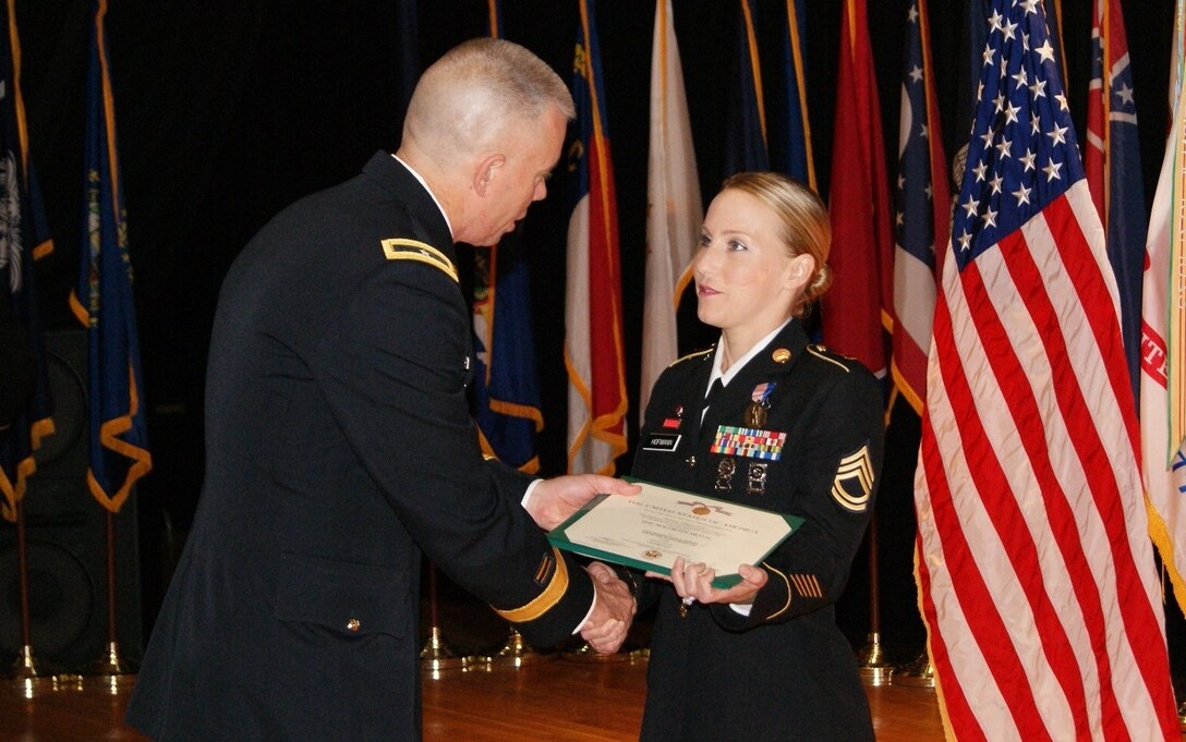 (Left) Brig. Gen. Aaron Walter, commander for the 100th Training Division, presents the Soldier's Medal to Sgt. 1st Class Alicia Hofmann at an award ceremony at Fort Knox, Kentucky, Sept. 29, 2017. Assigned to the 8th Regiment, 100th Health Services Battalion, 4th Brigade, 100th TD, Hofmann was awarded the Soldier's Medal for risking her life to save a man from a car accident that occurred on Oct. 4, 2014 in Saline, Michigan.