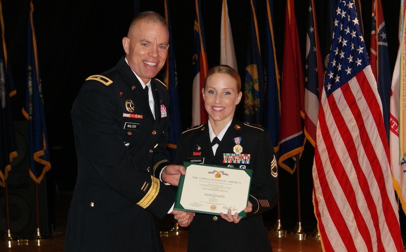 Brig. Gen. Aaron Walter, commander for the 100th Training Division, presents the Soldier's Medal to Sgt. 1st Class Alicia Hofmann at an award ceremony at Fort Knox, Kentucky, Sept. 29, 2017. Assigned to the 8th Regiment, 100th Health Services Battalion, 4th Brigade, 100th TD, Hofmann was awarded the Soldier's Medal for risking her life when she saved a man from a burning car accident that occurred on Oct. 4, 2014 in Saline, Michigan.