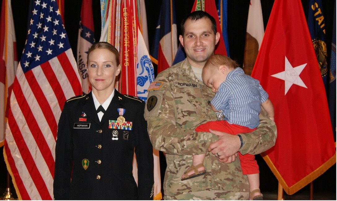 (Left to right) Sgt. 1st Class Alicia Hofmann, her husband Staff Sgt. David Hofmann, and one-year-old son Luke pose for photographs at Sgt. 1st Class Hofmann's Soldier's Medal ceremony held at Fort Knox, Kentucky, Sept. 29, 2017. She was awarded the Soldier's Medal for risking her life to save a man from a car accident that occurred on Oct. 4, 2014 in Saline, Michigan.
