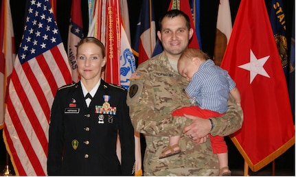 (Left to right) Sgt. 1st Class Alicia Hofmann, her husband Staff Sgt. David Hofmann, and one-year-old son Luke pose for photographs at Sgt. 1st Class Hofmann's Soldier's Medal ceremony held at Fort Knox, Kentucky, Sept. 29, 2017. She was awarded the Soldier's Medal for risking her life to save a man from a car accident that occurred on Oct. 4, 2014 in Saline, Michigan.