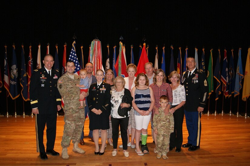 (Left to right) Sgt. 1st Class Alicia Hofmann, her husband Staff Sgt. David Hofmann, and one-year-old son Luke pose for photographs at Sgt. 1st Class Hofmann's Soldier's Medal ceremony held at Fort Knox, Kentucky, Sept. 29, 2017. She was awarded the Soldier's Medal for risking her life to save a man from a car accident that occurred on Oct. 4, 2014 in Saline, Michigan.