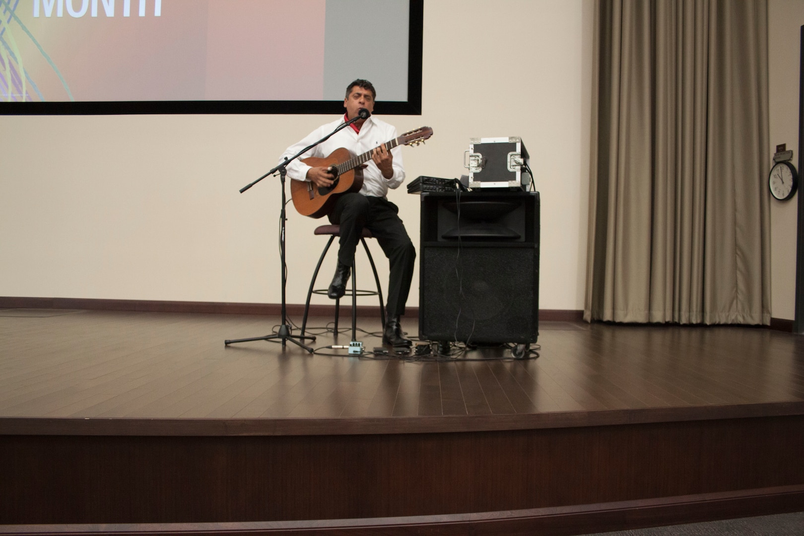 Dante Sobrevilla performs a medley of songs from different Hispanic countries during the Hispanic Heritage Month event at DLA Distribution Headquarters on Sept. 20.