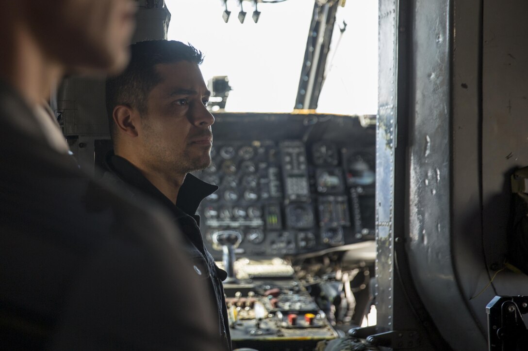 Wilmer Valderrama, a leading cast member of the CBS hit drama “NCIS: Naval Criminal Investigations,” listens to a Marine explain the capabilities of a CH-53E Super Stallion during a USO tour at Marine Corps Air Station Miramar, Calif., Sept. 30. Leading cast members from the hit CBS drama “NCIS: Naval Criminal Investigations,” Brian Dietzen, Duane Henry, Sean Murray and Valderrama viewed three different aircraft platforms with 3rd Marine Aircraft Wing and attended a luncheon with Marines prior to a question-and-answer session and show screening. (U.S. Marine Corps photo by Sgt. Lillian Stephens/Released)