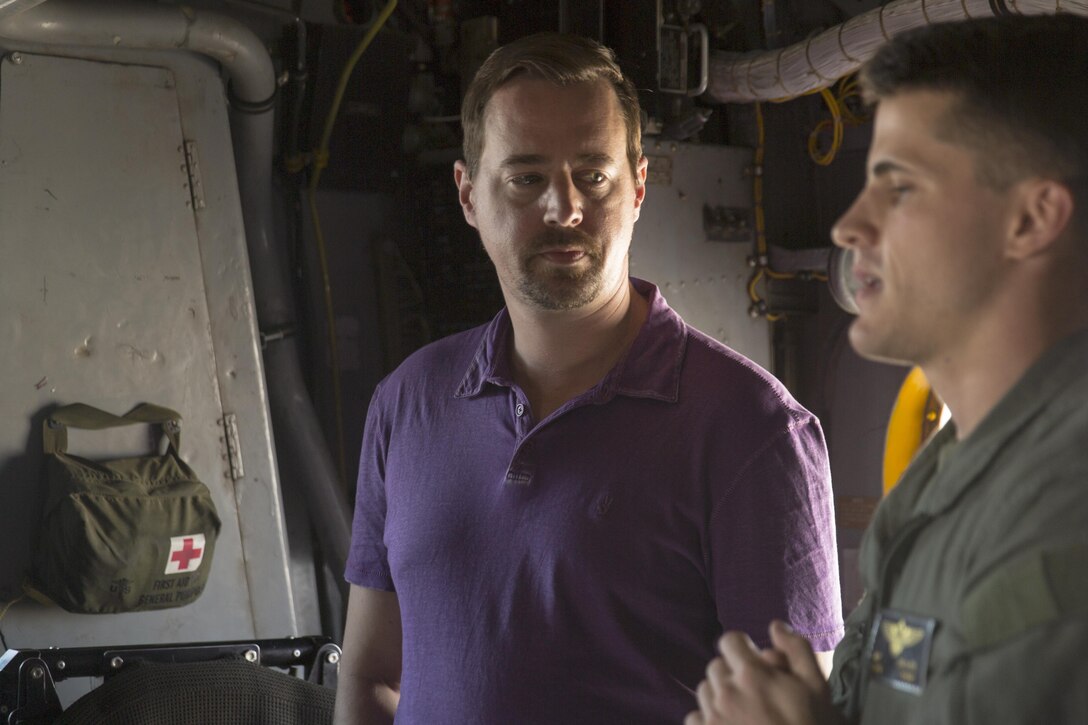 Sean Murray, a leading cast member of the CBS hit drama “NCIS: Naval Criminal Investigations,” listens as Capt. Michael Taylor, a CH-53E Super Stallion pilot, explains the capabilities of the aircraft during a USO tour at Marine Corps Air Station Miramar, Calif., Sept. 30. Leading cast members from the hit CBS drama “NCIS: Naval Criminal Investigations,” Brian Dietzen, Duane Henry, Murray and Wilmer Valderrama viewed three different aircraft platforms with 3rd Marine Aircraft Wing and attended a luncheon with Marines prior to a question-and-answer session and show screening. (U.S. Marine Corps photo by Sgt. Lillian Stephens/Released)