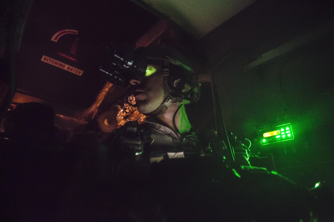 A Team Leader with the Force Reconnaissance Company, III Marine Expeditionary Force stationed at Camp Schwab in Okinawa, Japan checks over his team prior to reaching their high altitude release point in Parker, Ariz., from July 12 to Aug 1, 2017. The Marines conducted high altitude high opening (HAHO) sustainment training, while implementing the Joint Precision Air Drop System (JPADS). The Marine shown in the photo is the team leader and is tracking his team and the drop zone position.