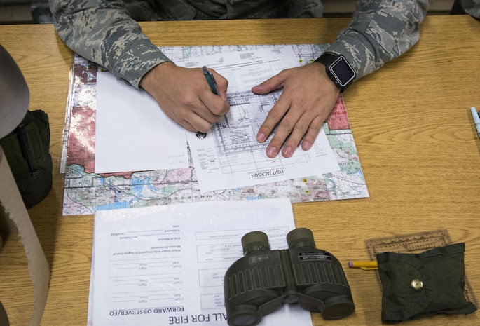Senior Airman Ryan Deetman, 628th Logistics Readiness Squadron central storage journeyman, plots coordinates on a map during land navigation training at McCrady Army National Guard Training Center, S.C., Sept. 26, 2017.