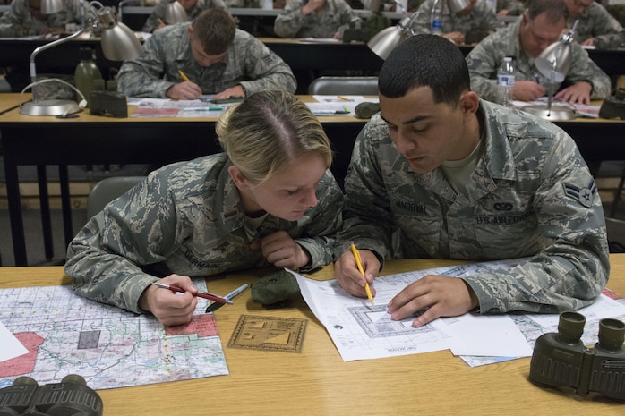 2nd Lt. Darby Germain, 628th Force Support Squadron fitness and sports officer in charge, and Airman 1st Class Hernan Sandoval, 628th Civil Engineer Squadron engineer assistant, plot coordinates on a map during a modified version of Warfighter Skills Training at McCrady Army National Guard Training Center, S.C., Sept. 26, 2017.