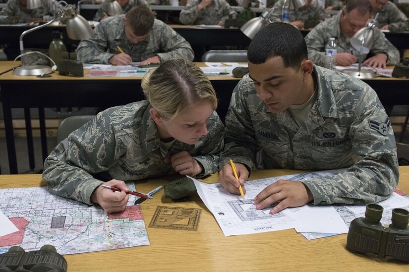 2nd Lt. Darby Germain, 628th Force Support Squadron fitness and sports officer in charge, and Airman 1st Class Hernan Sandoval, 628th Civil Engineer Squadron engineer assistant, plot coordinates on a map during a modified version of Warfighter Skills Training at McCrady Army National Guard Training Center, S.C., Sept. 26, 2017.