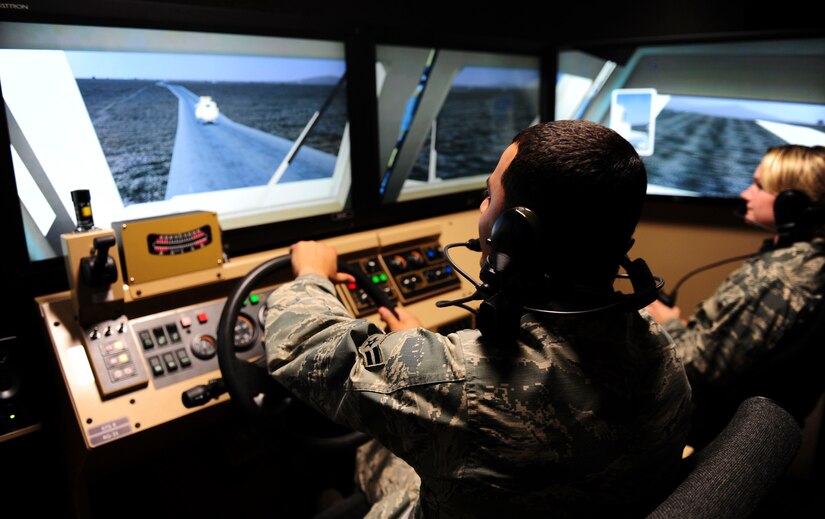 Airman 1st Class Hernan Sandoval, 628th Civil Engineer Squadron engineer assistant, and 2nd Lt. Darby Germain, 628th Force Support Squadron fitness and sports officer in charge, practice a convoy operation in a virtual simulator at McCrady Army National Guard Training Center, S.C., Sept. 28, 2017.