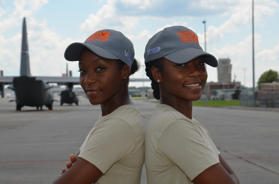 Shaina Williams, left, and Shannon Barber, Dobbins 94th Airlift Wing development and training flight trainees, pose for a photo on the flightline at Dobbins Air Reserve Base, Ga. July 9, 2017. Williams and Barber are identical twins and are preparing to go to basic military training later this year. (U.S. Air Force photo/Senior Airman Lauren Douglas)