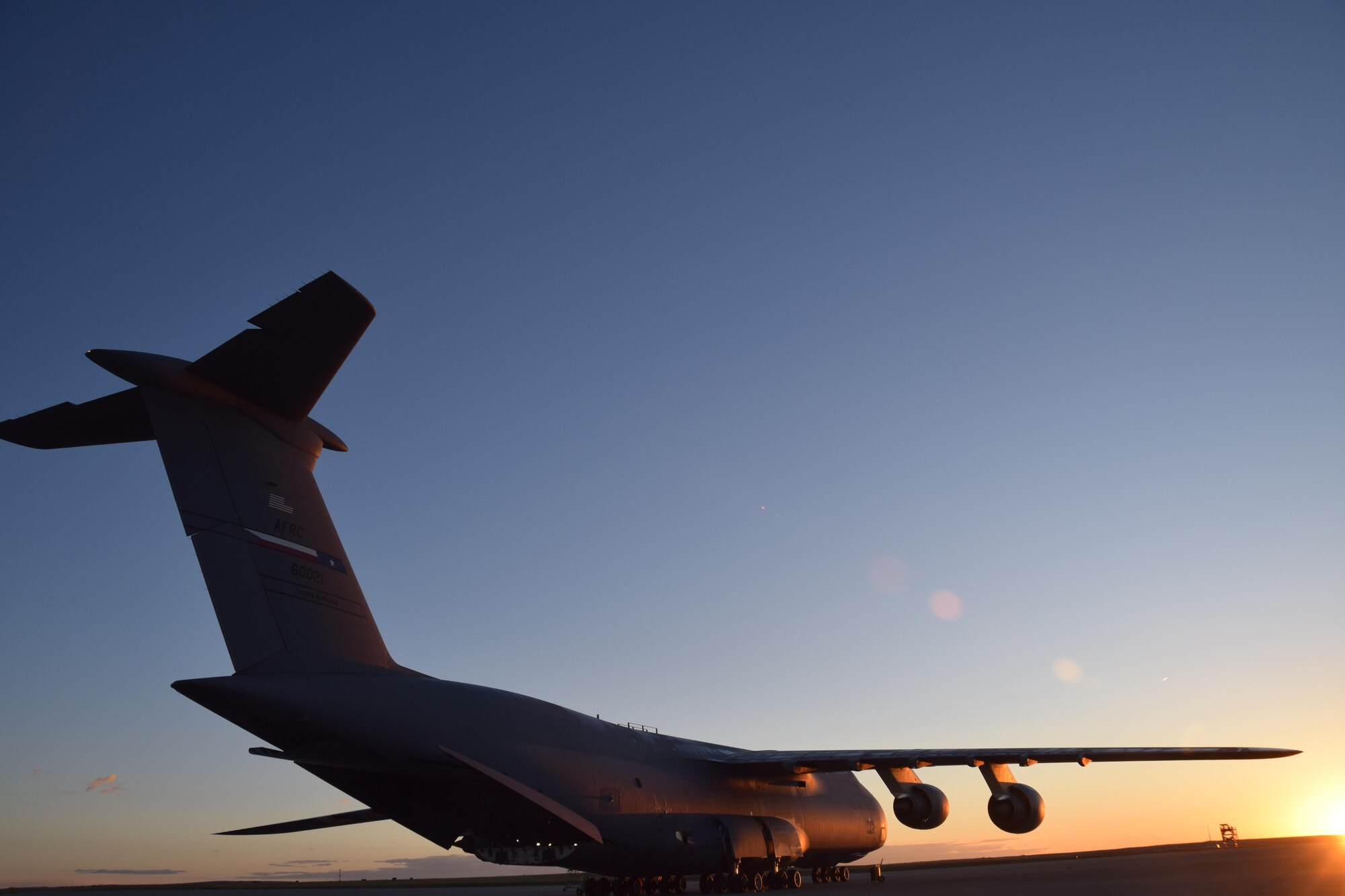 An Air Force Reserve Command C-5M Super Galaxy, which is assigned to the 433rd Airlift Wing at Joint Base San Antonio-Lackland, Texas, awaits cargo and personnel in Colorado Springs, Colorado, Oct. 1, 2017.  The mission included transporting 11 Soldiers from the 247th Composite Supply Company, 68th Sustainment Support Battalion, 4th Sustainment Brigade, 4th Infantry Division, supplies, fuel trucks and a communications vehicle to be employed in Hurricane Maria relief efforts in Puerto Rico. (photo by Tech. Sgt. Carlos J. Treviño)
