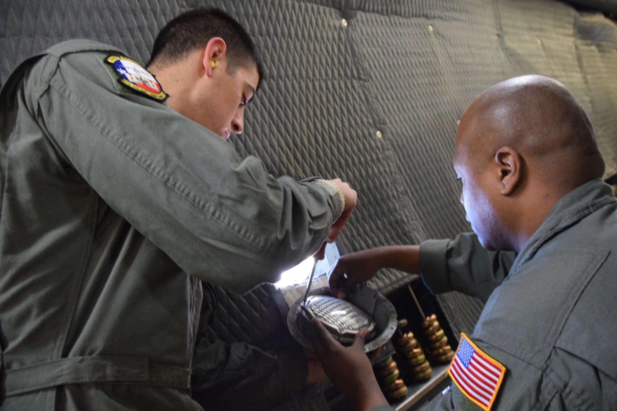 Senior Airmen Antonio Farias, 433rd Aircraft Maintenance Squadron and Tech. Sgt. Michael Saldana, 433rd Maintenance Squadron crew chiefs, fix an exterior lighting on an Air Force Reserve Command C-5M Super Galaxy, assigned to the 433rd Airlift Wing during a stop at Colorado Springs, Colorado. The Reserve Citizen Airmen  were part of an aircrew taking Soldiers with the 24th Composite Supply Company, 68th Sustainment Support Battalion, 4th Sustainment Brigade, 4th Infantry Division, supplies, fuel trucks and a communications vehicle to be employed in Hurricane Maria relief efforts in Puerto Rico. (U.S.  Air Force photo by Tech. Sgt. Carlos J. Treviño)