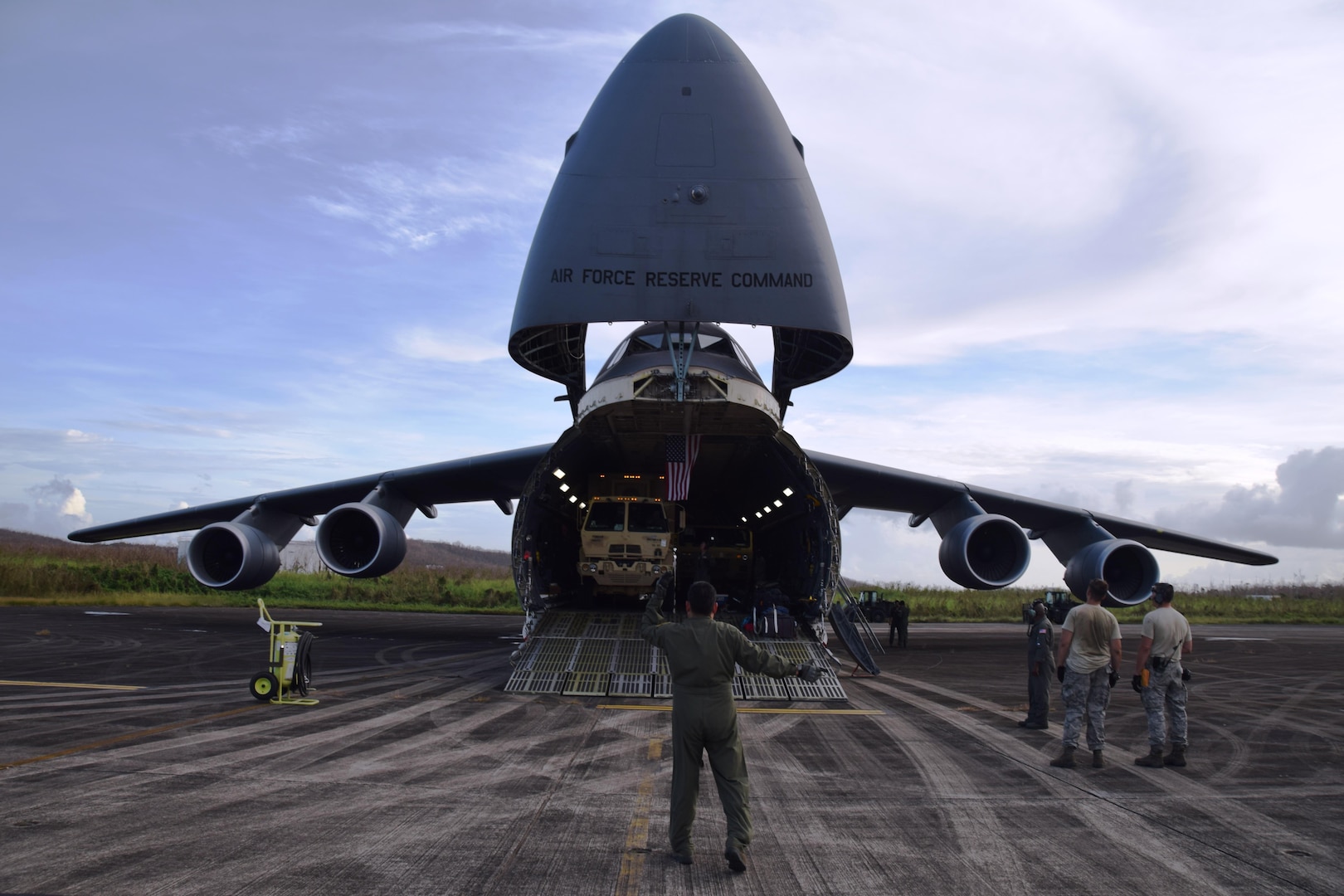 Master Sgt. Michael Lopez, 68th Airlift Squadron loadmaster, directs a vehicle off of a C-5M Super Galaxy, flown by Air Force Reserve Citizen Airmen with the 433rd Airlift Wing from Joint Base San Antonio-Lackland, Texas, after landing at Ceiba, Puerto Rico Oct. 1, 2017. The Alamo Wing’s Reserve Citizen Airmen have flown 17 missions during the past month to aid hurricane recovery efforts in the United States and its territories to include Puerto Rico and the U.S. Virgin Islands.  (U.S.  Air Force photo by Tech. Sgt. Carlos J. Treviño