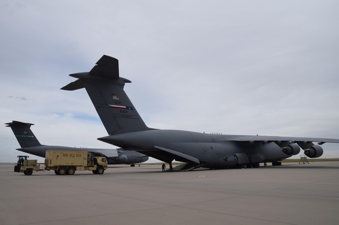A Joint Incident Site Communications Capability (JISCC) vehicle is loaded onto a  433rd Airlift Wing C-5M Super Galaxy at Ft. Carson, Colo. Oct. 1, 2017. The C-5M, flown by Citizen Airmen from Joint Base San Antonio-Lackland, Texas, is taking the JISCC,  24 Soldiers, supplies and two fuel trucks to Puerto Rico to aid hurricane recovery efforts that have affected the United States and its territories  in the Caribbean. (U.S.  Air Force photo by Tech. Sgt. Carlos J. Treviño)