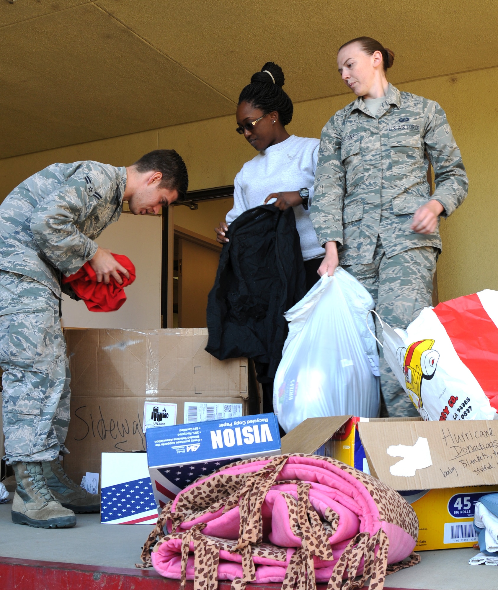 Beale Airmen pack donated clothes and goods.