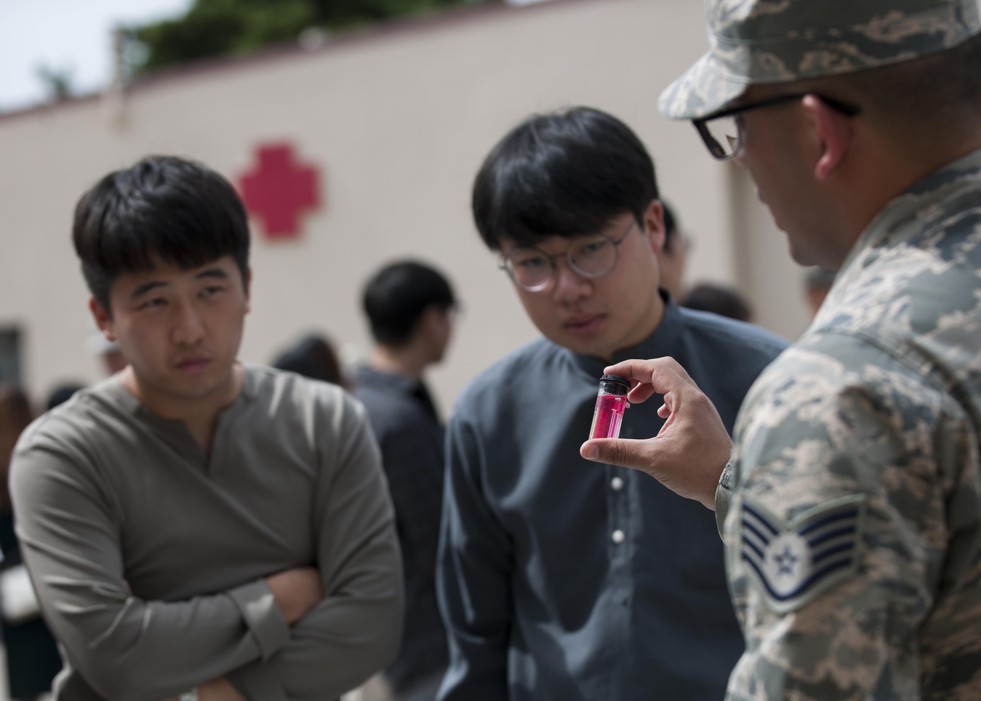 U.S. Air Force Staff Sgt. Hector Mendez-Chaves, 8th Medical Group Bioenvironmental Engineering health operations NCOIC, shows what happens when water is tested on base to environmental engineering students from Kunsan National University during a tour at Kunsan Air Base, Republic of Korea, Sept. 29, 2017. During the tour, students where taught about the correlation between the environment and health and what the 8th MDG is doing to minimize risks to the Airmen and civilians on base. (U.S. Air Force photo by Staff Sgt. Victoria H. Taylor)