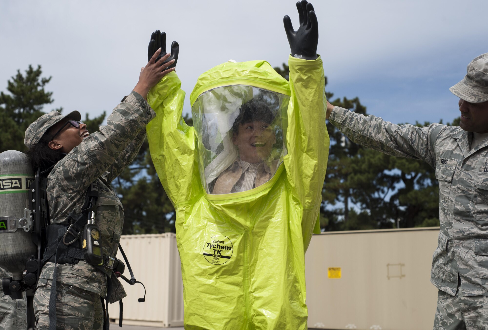U.S. Air Force Master Sgt. Ambree Evans, 8th Medical Group Bioenvironmental Engineering health operations NCOIC, and Staff Sgt. Adam Ruiz, 8 MDG industrial hygiene NCOIC, help a student from Kunsan National University don protective gear while on tour at Kunsan Air Base, Republic of Korea, Sept. 29, 2017.  During the tour, the environmental engineering students were taught about the correlation between the environment and health and what the 8th MDG is doing to minimize risks to the Airmen and civilians on base. (U.S. Air Force photo by Staff Sgt. Victoria H. Taylor)