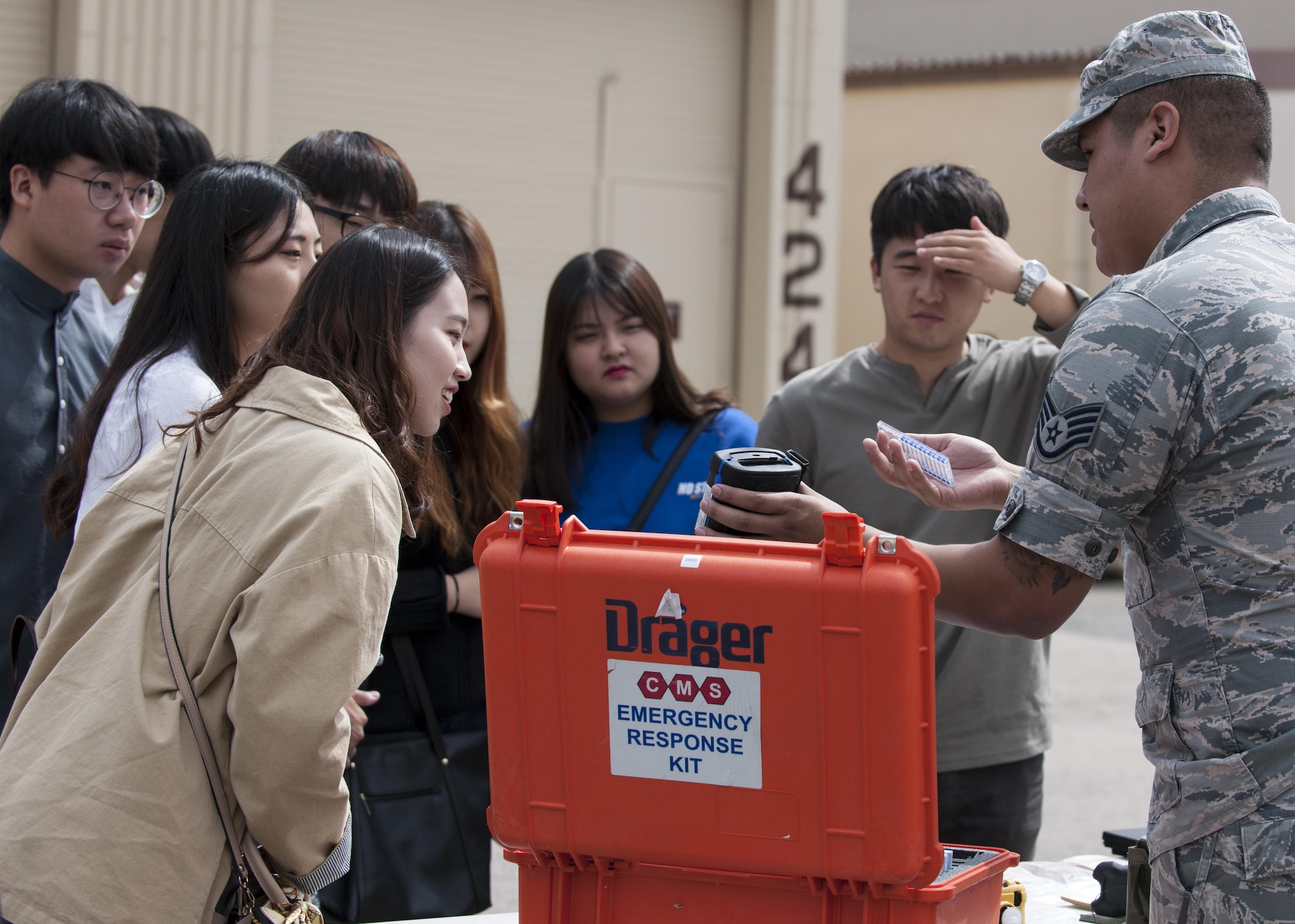 U.S. Air Force Staff Sgt. Antonio Aguilera, 8th Medical Group Bioenvironmental Engineering readiness and training NCOIC, explains the contents of an Emergency Response Kit to environmental engineering students of Kunsan National University during a tour at Kunsan Air Base, Republic of Korea, Sept. 29, 2017. During the tour, students were taught about what steps are taken to ensure mission-ready medics ensuring “Fight Tonight” capability. (U.S. Air Force photo by Staff Sgt. Victoria H. Taylor)