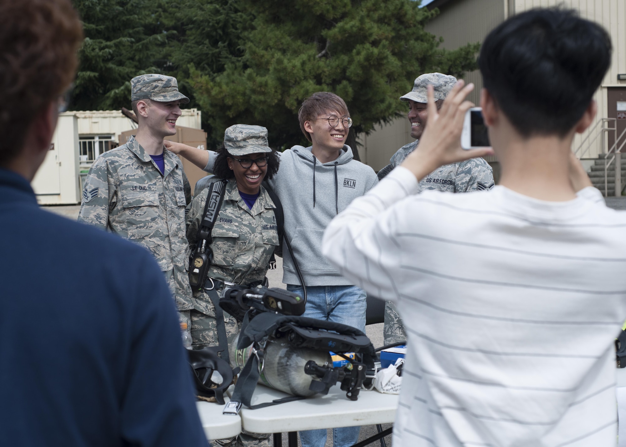 U.S. Air Force Airmen and environmental engineering students from Kunsan National University pose for a photo while visiting Kunsan Air Base, Republic of Korea, Sept. 29, 2017. During the tour, students were taught about what steps are taken to ensure mission-ready medics to strengthen the Wolf Pack’s “Fight Tonight” capability. (U.S. Air Force photo by Staff Sgt. Victoria H. Taylor)