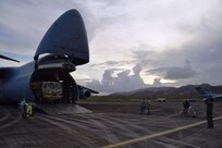 Storm clouds and a Caribbean sunset watch over Reserve Citizen Airmen as they unload a Joint Incident Site Communications Capability (JISCC) vehicle from an Air Force Reserve Command 433rd Airlift Wing C-5M Super Galaxy at Ceiba, Puerto Rico Oct. 1, 2017. The JISCC vehicle will provide satellite service while interlacing communication assets between the two agencies with internet, telephone, and radio communication. (U.S.  Air Force photo by Tech. Sgt. Carlos J. Treviño)