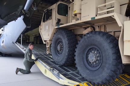 Senior Master Sgt. Kevin Foerster, a 68th Airlift Squadron loadmaster, watches for safe clearance as a vehicle drives onto an Air Force Reserve Command C-5M Super Galaxy, prior to takeoff from Colorado Springs, Colorado, Oct. 1, 2017. The Air Force Reserve’s 433rd Airlift Wing from Joint Base San Antonio-Lackland, Texas has flown 17 missions to aid hurricane recovery efforts in the United States and its territories to include Puerto Rico and the U.S. Virgin Islands.  (U.S.  Air Force photo by Tech. Sgt. Carlos J. Treviño)