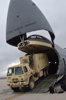A Joint Incident Site Communications Capability (JISCC) vehicle is loaded onto an Air Force Reserve Command C-5M Super Galaxy at Colorado Springs, Colorado Oct. 1, 2017. The C-5M, flown by Citizen Airmen with the 433rd Airlift Wing, Joint Base San Antonio-Lackland, Texas, took the JISCC, 11 Soldiers, supplies and two fuel trucks to Puerto Rico to aid hurricane recovery efforts that have affected the United States and its territories. (U.S.  Air Force photo by Tech. Sgt. Carlos J. Treviño)