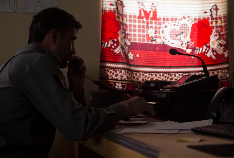 An Afghan National Defense and Security Force policeman radios an adjacent unit from the Operational Coordination Center – Regional at Bost Airfield, Afghanistan, Oct. 3, 2017. One of the primary missions of the Operational Coordination Center - Regional is to maintain situational awareness with operational forces on the ground and provide information to ground commanders so they can manage their forces and resources effectively. (U.S. Marine Corps photo by Sgt. Justin T. Updegraff)